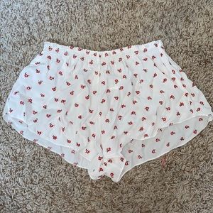 white flowy shorts with red flowers